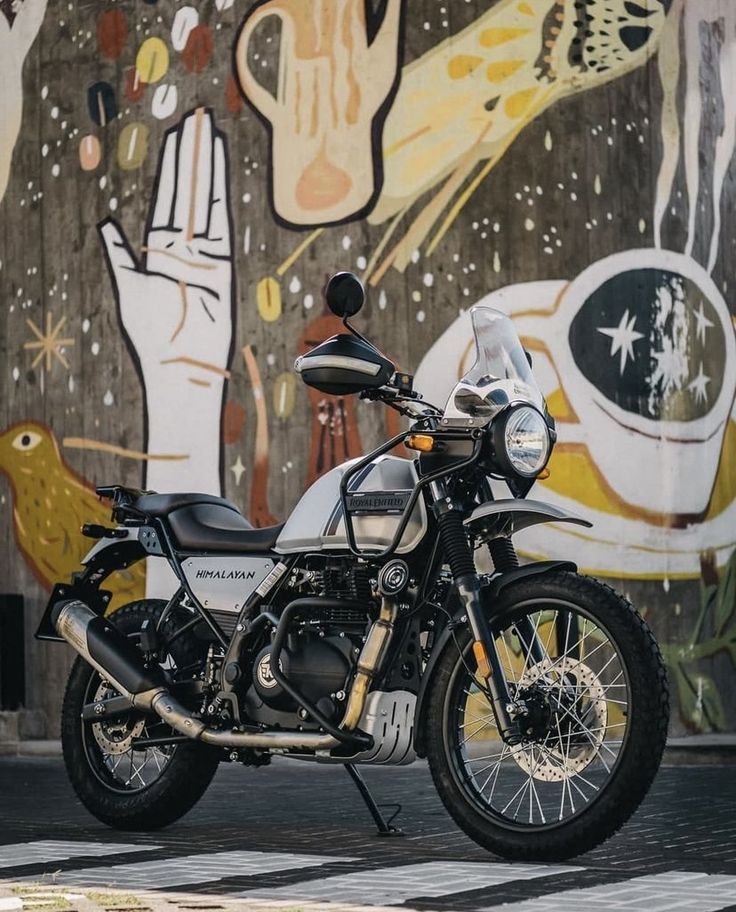 Mechanic inspecting a Himalayan bike inside a garage